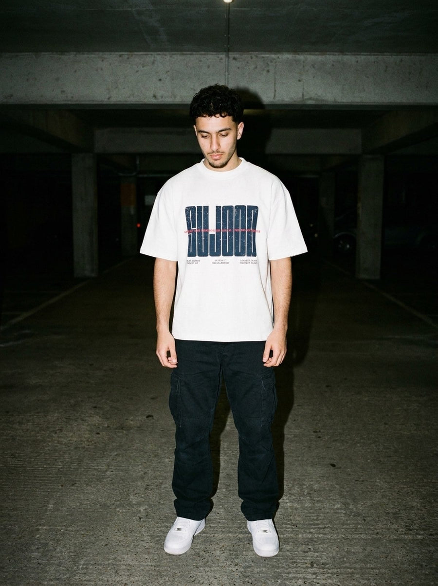 Sujood for the Heart white tee photographed in a garage at night