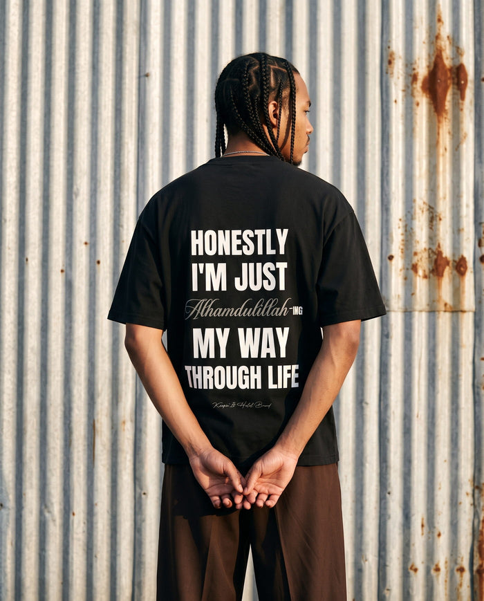 Honestly, Alhamdulillah black boxy tee back print against corrugated metal