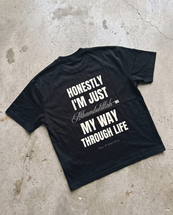 Honestly, Alhamdulillah black boxy tee laid back-side-up on concrete