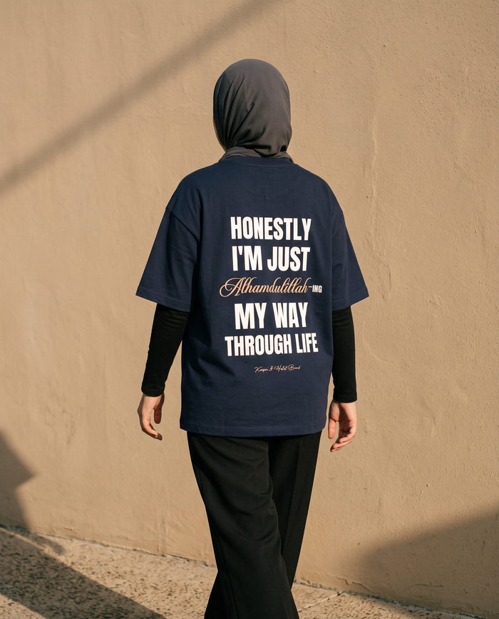 Honestly, Alhamdulillah navy boxy tee back print walking past an adobe wall