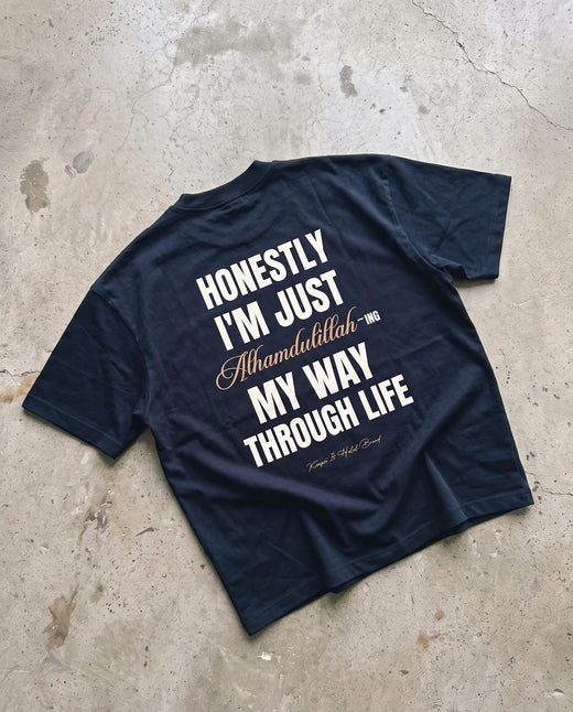 Honestly, Alhamdulillah navy boxy tee laid back-side-up on concrete