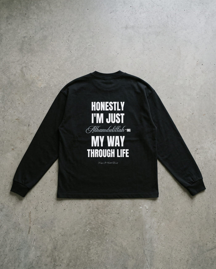 Honestly, Alhamdulillah black long sleeve laid back-side-up on concrete