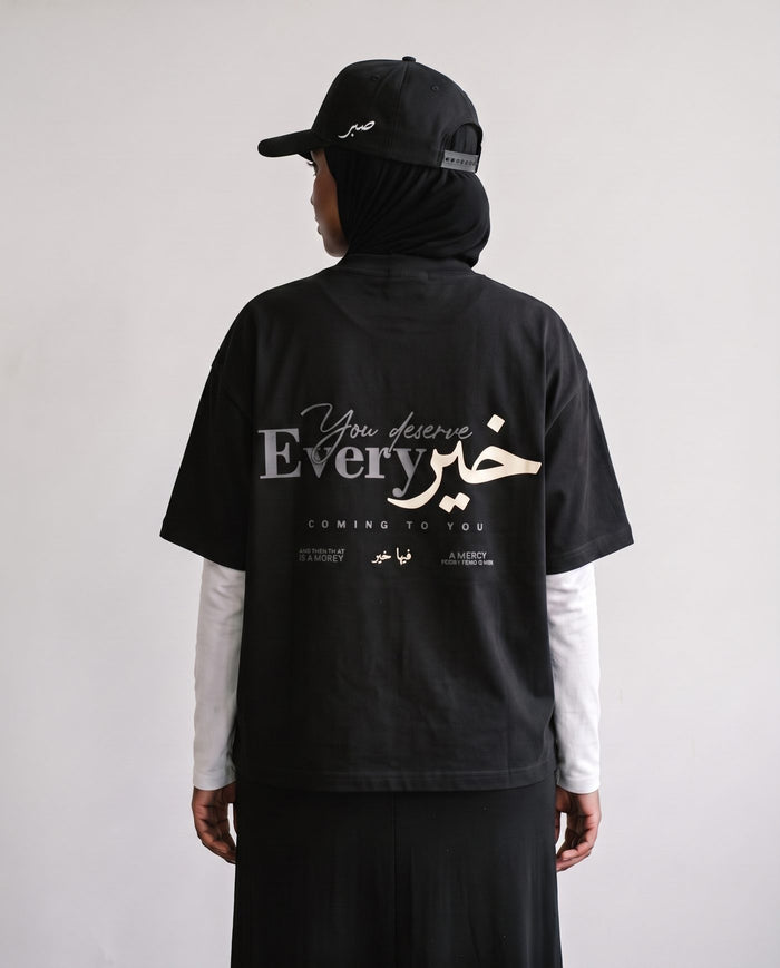 You Deserve Every Khayr black boxy tee back print, looking over the shoulder