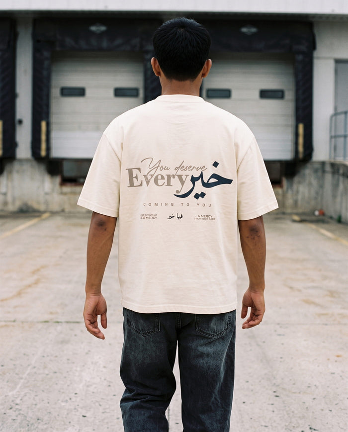 You Deserve Every Khayr natural boxy tee back print at a loading dock