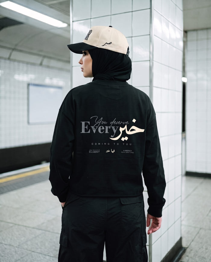 You Deserve Every Khayr black long sleeve back print on a subway platform