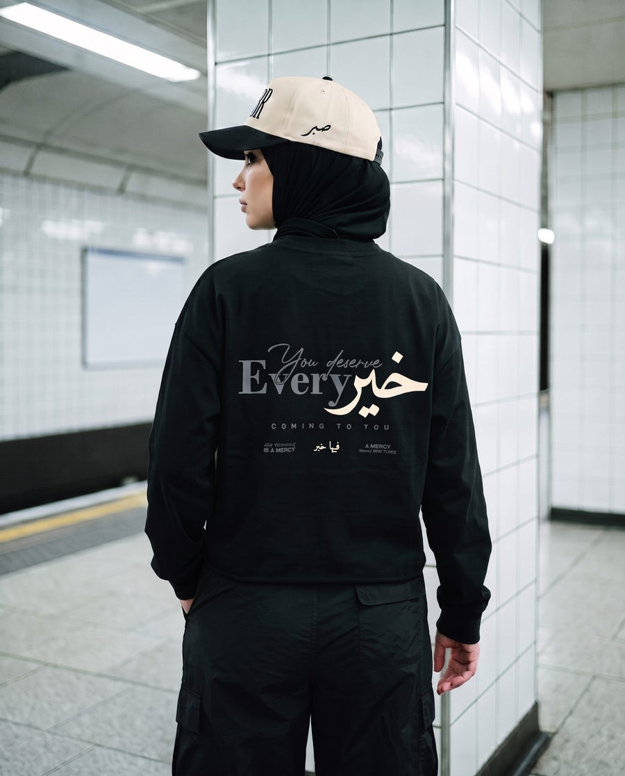 You Deserve Every Khayr black long sleeve back print on a subway platform