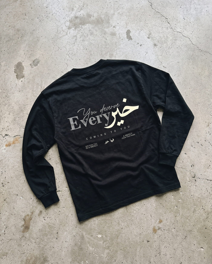 You Deserve Every Khayr black long sleeve laid back-side-up on concrete
