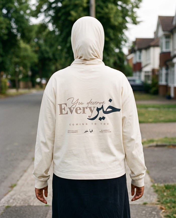 You Deserve Every Khayr bone long sleeve back print walking a residential street