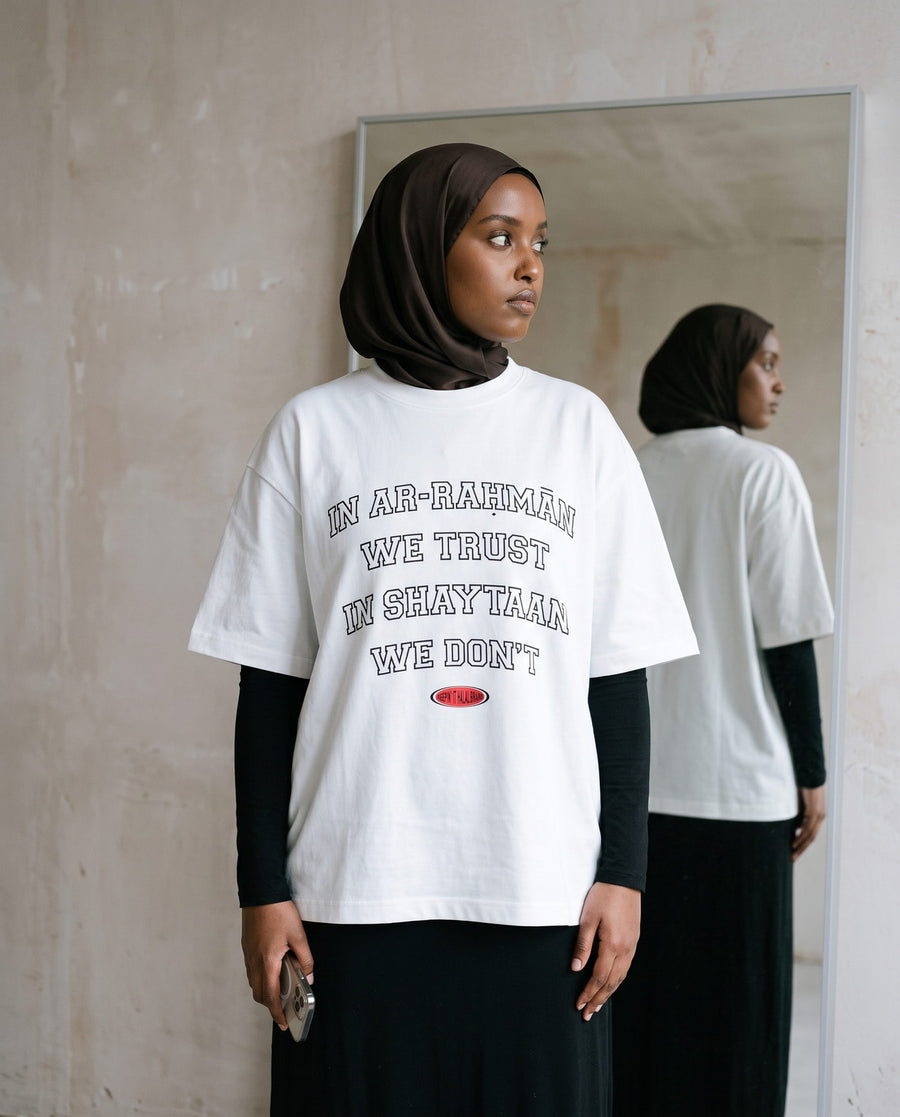 In Ar-Rahman We Trust white boxy tee in a full-length mirror
