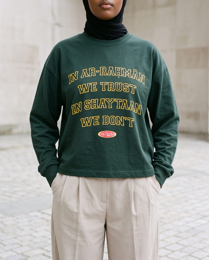 In Ar-Rahman We Trust hunter green long sleeve on a granite square