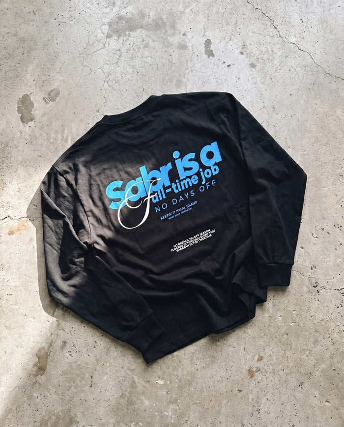 Full-Time Sabr black long sleeve laid back-side-up on concrete