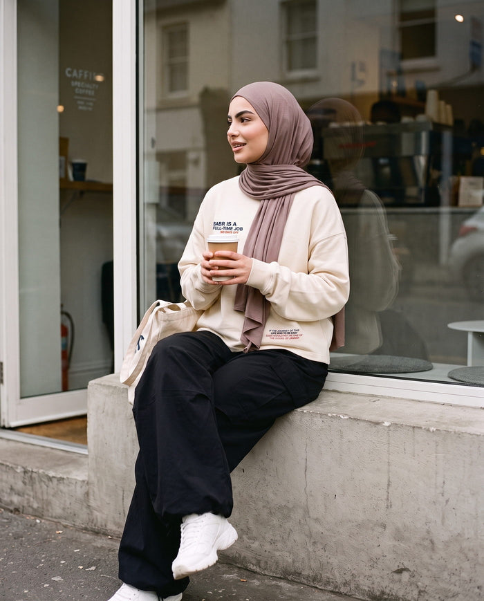 Full-Time Sabr bone long sleeve, front view, outside a coffee shop
