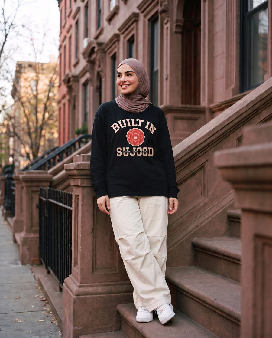 Built in Sujood black long sleeve on brownstone steps